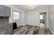 Dining area featuring a window and view into the kitchen, with wood-look flooring at 117 W 36Th St, Indianapolis, IN 46208