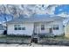 Charming home exterior with an inviting front porch and well-maintained yard at 117 W 36Th St, Indianapolis, IN 46208