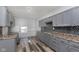 Bright kitchen with grey cabinets, mosaic tile backsplash, and stainless steel sink at 117 W 36Th St, Indianapolis, IN 46208