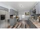 Kitchen with stainless steel appliances, wooden floor, granite countertops, and mosaic backsplash at 117 W 36Th St, Indianapolis, IN 46208