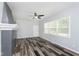Bright living room featuring stylish floors, a ceiling fan, and a charming fireplace at 117 W 36Th St, Indianapolis, IN 46208
