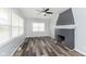 Spacious living room with a cozy fireplace, lots of natural light, and wood flooring at 117 W 36Th St, Indianapolis, IN 46208