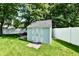 A well-maintained backyard with a storage shed and white fence at 11710 E 75Th St, Indianapolis, IN 46236