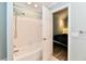 Bright bathroom featuring a shower over tub and doorway to a cozy bedroom at 11710 E 75Th St, Indianapolis, IN 46236