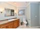 Bathroom with framed mirror over vanity, artwork, and neutral blue walls at 11710 E 75Th St, Indianapolis, IN 46236
