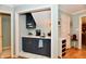 A cozy breakfast bar includes blue shaker cabinets and a white countertop at 11710 E 75Th St, Indianapolis, IN 46236