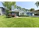 Charming two-story home with blue trim, attached garage, and lush green lawn at 11710 E 75Th St, Indianapolis, IN 46236