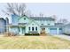 Two-story house with a blue door, chimney, and a three-car attached garage at 11710 E 75Th St, Indianapolis, IN 46236