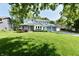 Charming two-story home with blue trim, attached garage, and lush green lawn at 11710 E 75Th St, Indianapolis, IN 46236