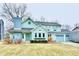 Charming two-story home with a blue door, chimney, three-car garage, and lawn at 11710 E 75Th St, Indianapolis, IN 46236