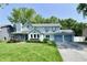 Charming two-story home with blue trim, attached garage, and lush green lawn at 11710 E 75Th St, Indianapolis, IN 46236