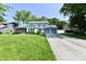 Charming two-story home with blue trim, attached garage, and lush green lawn at 11710 E 75Th St, Indianapolis, IN 46236