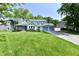 Charming two-story home with blue trim, attached garage, and lush green lawn at 11710 E 75Th St, Indianapolis, IN 46236