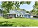 Charming two-story home with blue trim, attached garage, and lush green lawn at 11710 E 75Th St, Indianapolis, IN 46236