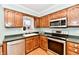 Traditional-style kitchen with stainless steel appliances and a sink under the window at 11710 E 75Th St, Indianapolis, IN 46236