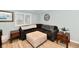 Comfortable living room features neutral tones, an ottoman and a view to the backyard at 11710 E 75Th St, Indianapolis, IN 46236