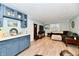Open-concept living room with breakfast bar, neutral tones, and backyard views at 11710 E 75Th St, Indianapolis, IN 46236