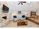 Spacious living room with stone fireplace, ceiling fan and comfortable seating area at 11710 E 75Th St, Indianapolis, IN 46236