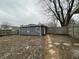 A backyard view with a detached garage and a stone paver walkway at 3314 S Parker Ave, Indianapolis, IN 46237
