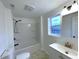 This bathroom has a shower and tub combination, vanity, and a window at 3314 S Parker Ave, Indianapolis, IN 46237