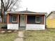 Charming home with front porch featuring white door, fresh paint, and well-manicured yard at 3314 S Parker Ave, Indianapolis, IN 46237