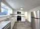 Bright updated kitchen with stainless steel appliances, white cabinets, and granite countertops at 3314 S Parker Ave, Indianapolis, IN 46237