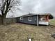 A house with fresh dark siding, fenced yard, and compact landscaping at 3314 S Parker Ave, Indianapolis, IN 46237