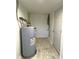 Utility room with water heater and tile flooring and a back door at 3314 S Parker Ave, Indianapolis, IN 46237