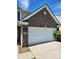 Attached two-car garage with brick facade and well-maintained concrete driveway at , Whitestown, IN 46075