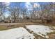 Spacious backyard featuring a mix of grass and snow, enclosed by a wooden fence, offering privacy and outdoor space at 3950 W Michigan St, Indianapolis, IN 46222