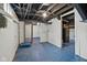 Unfinished basement with painted floor, exposed ceiling, and utility connections at 3950 W Michigan St, Indianapolis, IN 46222