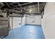 Unfinished basement with exposed pipes, mechanicals, and painted floor at 3950 W Michigan St, Indianapolis, IN 46222