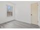 Bright bedroom with modern gray flooring and a large window letting in natural light at 3950 W Michigan St, Indianapolis, IN 46222
