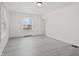 Bright bedroom with modern gray flooring and a large window letting in natural light at 3950 W Michigan St, Indianapolis, IN 46222