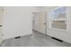Bright bedroom with neutral walls, modern gray flooring, and natural light from a large window at 3950 W Michigan St, Indianapolis, IN 46222