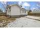 Side view of a charming home, showcasing its clean white siding and well-maintained exterior with a small backyard patch at 3950 W Michigan St, Indianapolis, IN 46222
