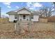 Charming home featuring a well-maintained lawn, fenced yard, and inviting front porch at 3950 W Michigan St, Indianapolis, IN 46222