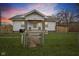Charming home featuring a well-maintained lawn, fenced yard, and inviting front porch at 3950 W Michigan St, Indianapolis, IN 46222