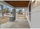View of front porch with wood ceiling, brick columns, and a concrete floor at 3950 W Michigan St, Indianapolis, IN 46222