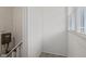 Hallway with white walls and trim; window with blinds let in light at 3950 W Michigan St, Indianapolis, IN 46222