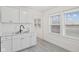 Kitchen area featuring modern gray floors and light cabinets and countertops at 3950 W Michigan St, Indianapolis, IN 46222