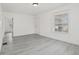 Bright living room with modern gray flooring and fresh white paint at 3950 W Michigan St, Indianapolis, IN 46222