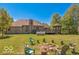 Large backyard with mature trees, fire pit area, and raised deck with gazebo and brick chimney at 4030 W 193Rd St, Westfield, IN 46074