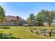 Expansive backyard featuring a spacious brick home, wooden deck, gazebo, and inviting fire pit area at 4030 W 193Rd St, Westfield, IN 46074