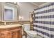 Stylish bathroom with granite countertop sink, wood-look tile accent wall, and a charming striped shower curtain at 4030 W 193Rd St, Westfield, IN 46074