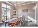 Formal dining room with modern chandelier, gray walls, dark hardwood floors and large window at 4030 W 193Rd St, Westfield, IN 46074