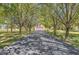 Long paved driveway with mature trees on either side, leading to a brick home with an attached garage at 4030 W 193Rd St, Westfield, IN 46074