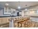 Charming kitchen with a unique stone bar, barstool seating, white cabinets, and modern stainless steel appliances at 4030 W 193Rd St, Westfield, IN 46074