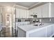 Kitchen featuring white cabinets, stainless steel appliances, grey subway tile and hardwood floors at 4030 W 193Rd St, Westfield, IN 46074
