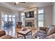 Cozy living room features a fireplace, plush seating, hardwood floors and a view to the dining area at 4030 W 193Rd St, Westfield, IN 46074